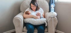 Mother Holding Baby While Breast Pumping