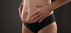 woman holding postpartum belly
