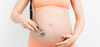 Pregnant Woman with Stethoscope on Belly