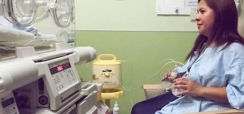 woman sitting on chair and breast pumping for her baby in the nicu