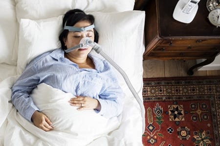 Sleeping pregnant woman with a sleep apnea machine